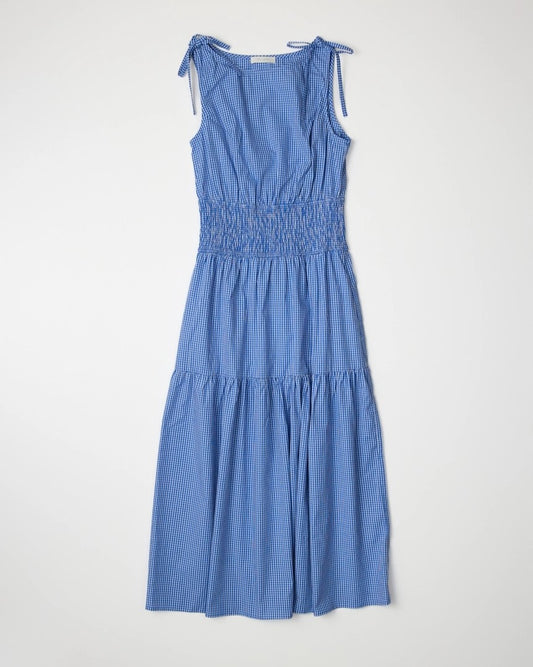 Blue gingham dress with tiers and a smocked waist and tie shoulder detail at Clad, a sustainable clothing store in Asheville, NC.