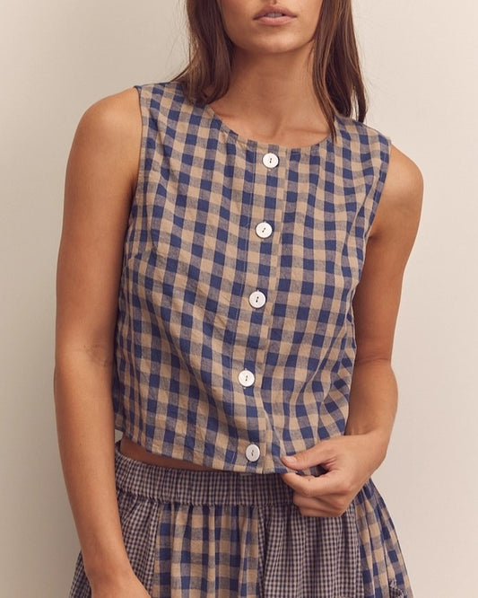 Navy gingham check button down top from Amente paired with its matching panel skirt at Clad, a sustainable clothing store in Asheville, NC.