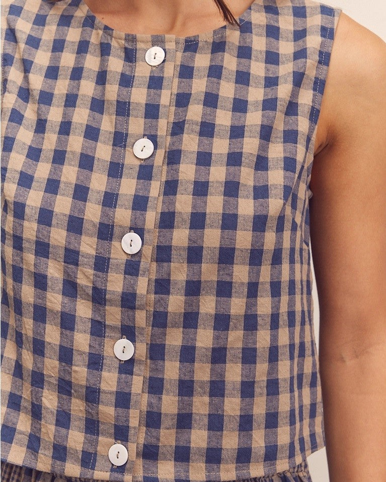 Navy gingham check button down top from Amente paired with its matching panel skirt at Clad, a sustainable clothing store in Asheville, NC.