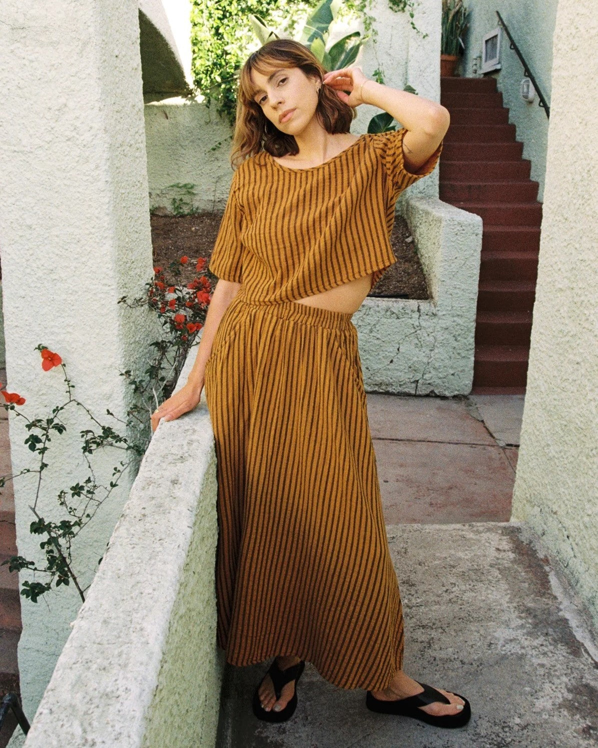 Curator Fawn avocado green stripe skirt at Clad, a sustainable clothing boutique in Asheville, NC. Paired with the matching Hanna top and black flats