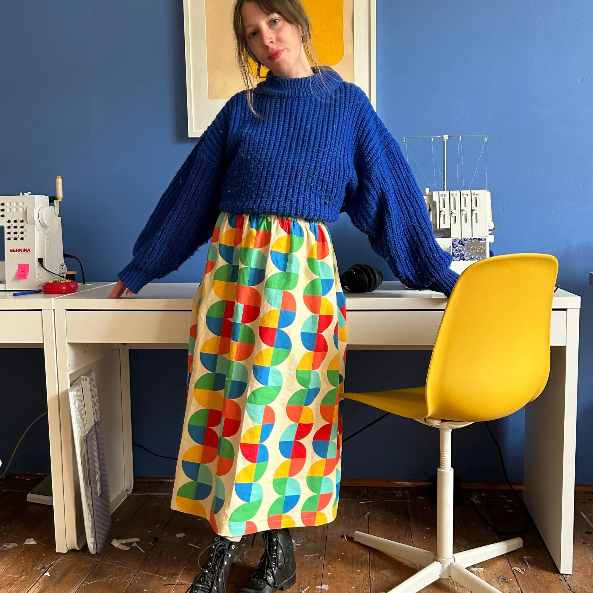 Ersa Fibers Charlie Skirt in Seesaw paired with combat boots and a chunky royal blue knit sweater at Clad, a sustainable clothing store in Asheville, NC.