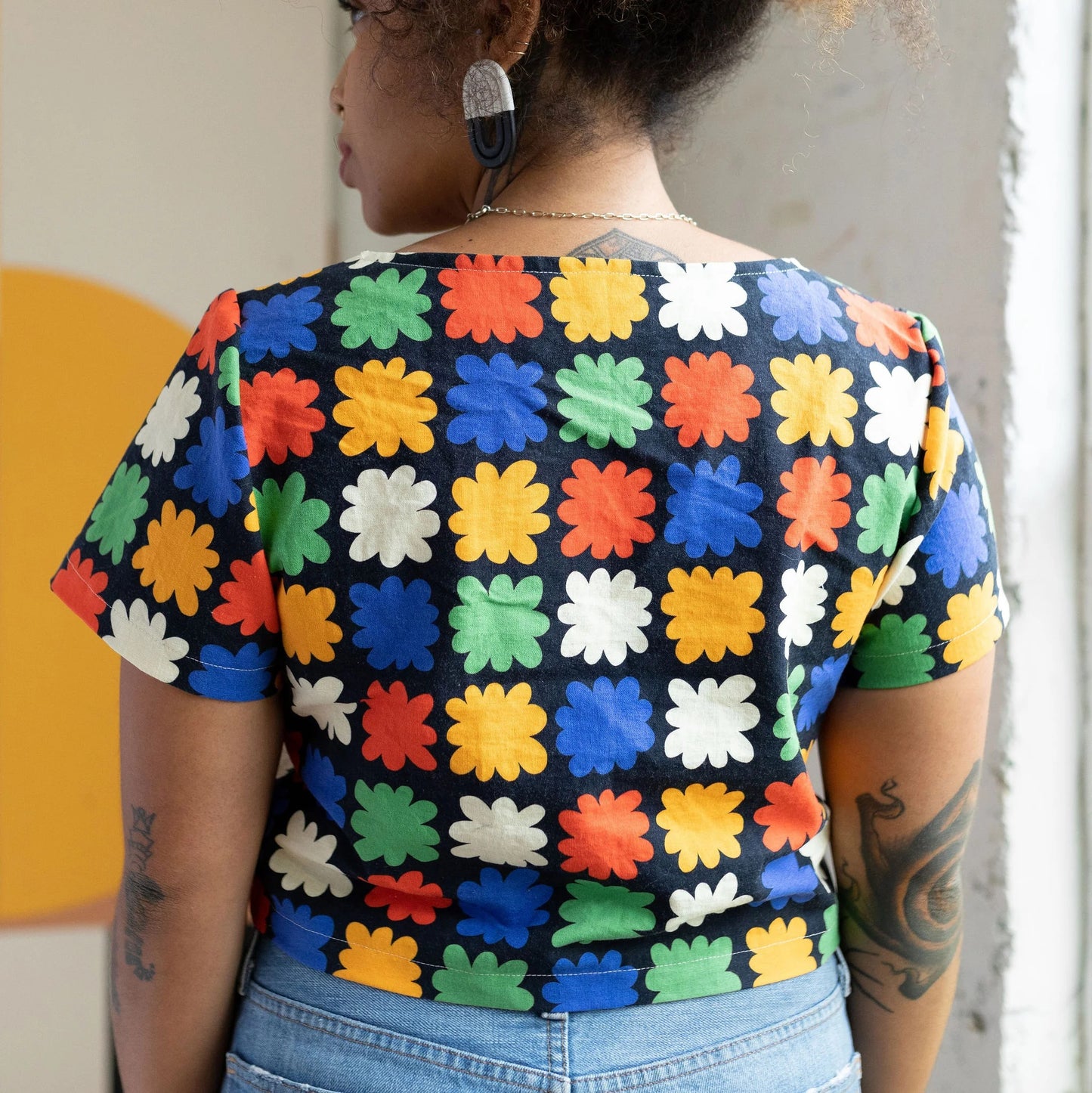 Abstract floral on black backround crop top with a square neckline by Ersa Fibers at Clad, a sustainable clothing boutique in Asheville, North Carolina.