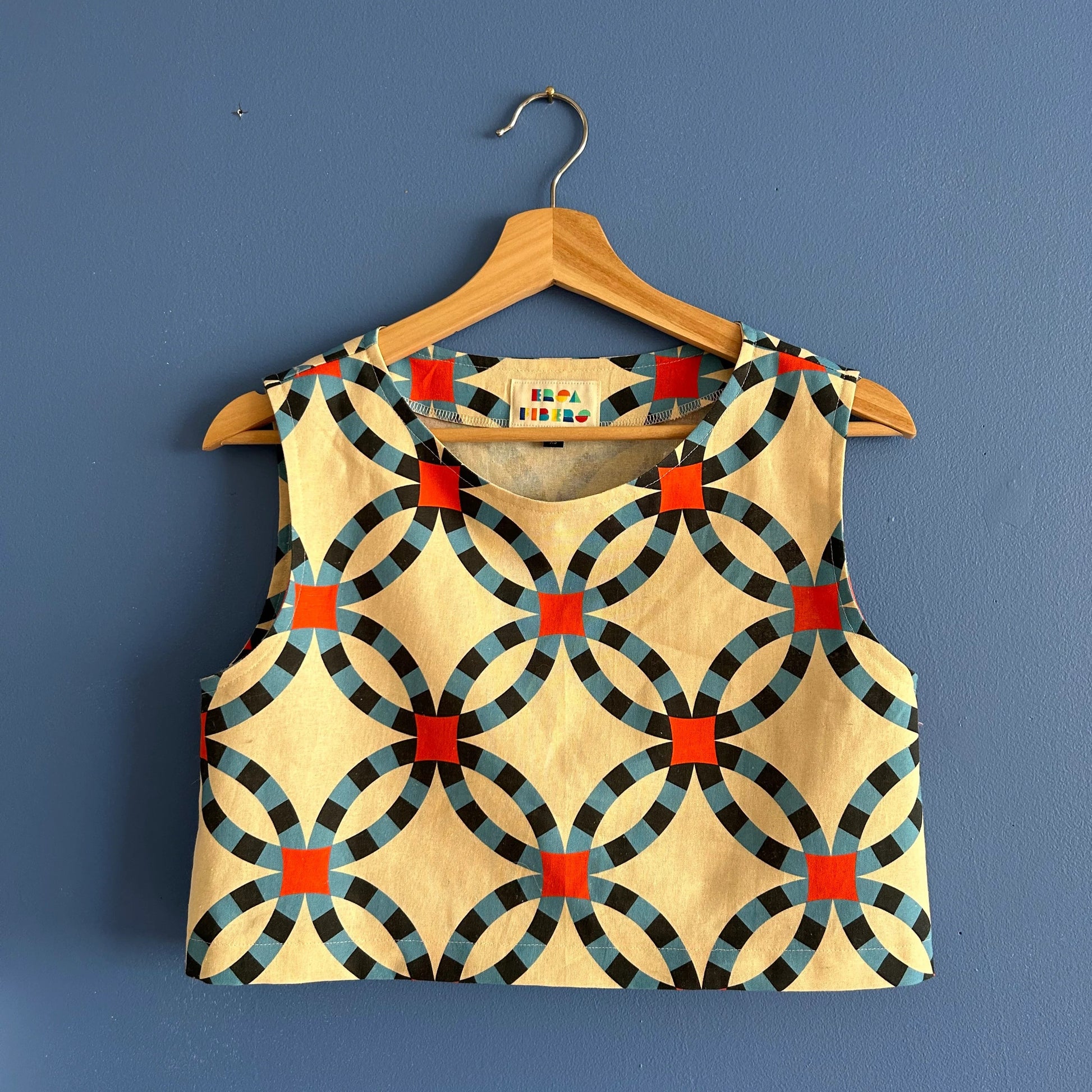 Double ring concentric circle linen crop top by Ersa Fibers with blue rings and red centers at Clad, a sustainable clothing store in Asheville, NC
