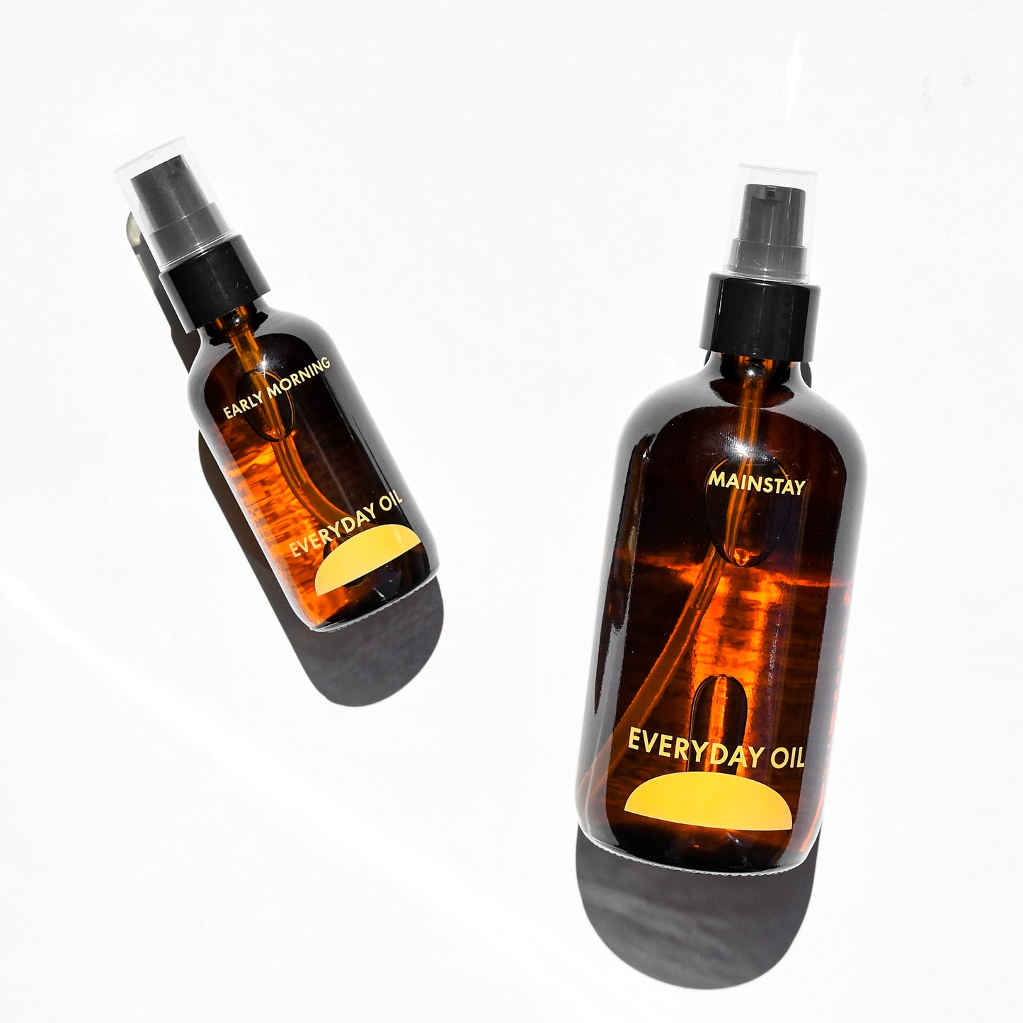 Everyday Oil body oil in Mainstay and Early Morning scents in full 8 oz and travel 2 oz sizes. Made in Black Mountain, NC.