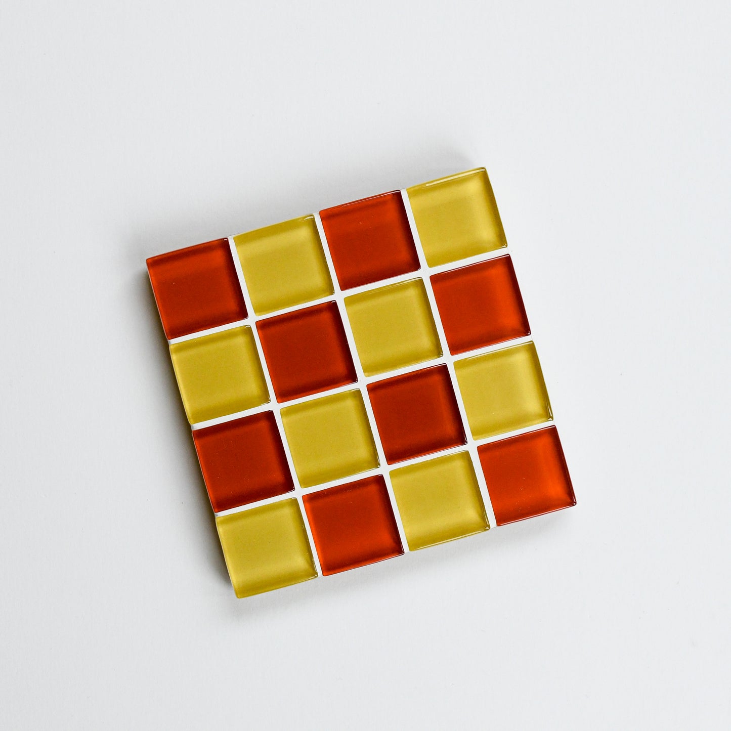 Vibrant, colorful glass tile coaster by Subtle Art Studios in Candy Cone with marigold yellow and poppy red orange tiles.