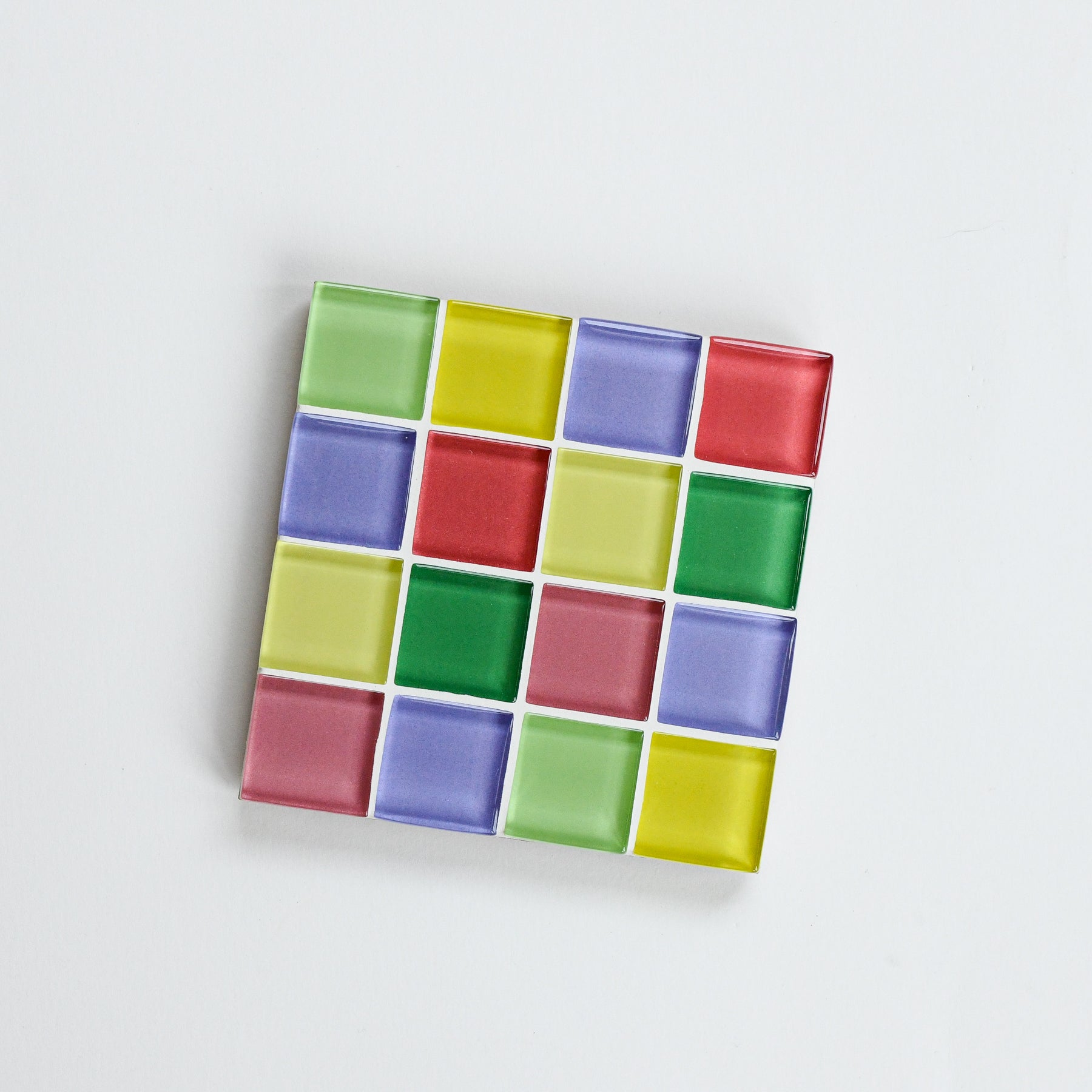 Vibrant, colorful glass tile coaster by Subtle Art Studios in Summer Sprinkles, with periwinkle, yellow, green, sage, terracotta, and blush tiles.