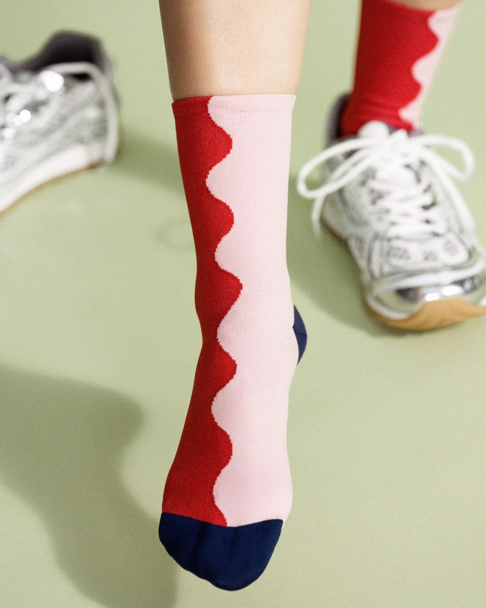 Wavy two-toned red and blush pink socks with a navy heel and toe at Clad, a sustainable clothing store in Asheville, NC