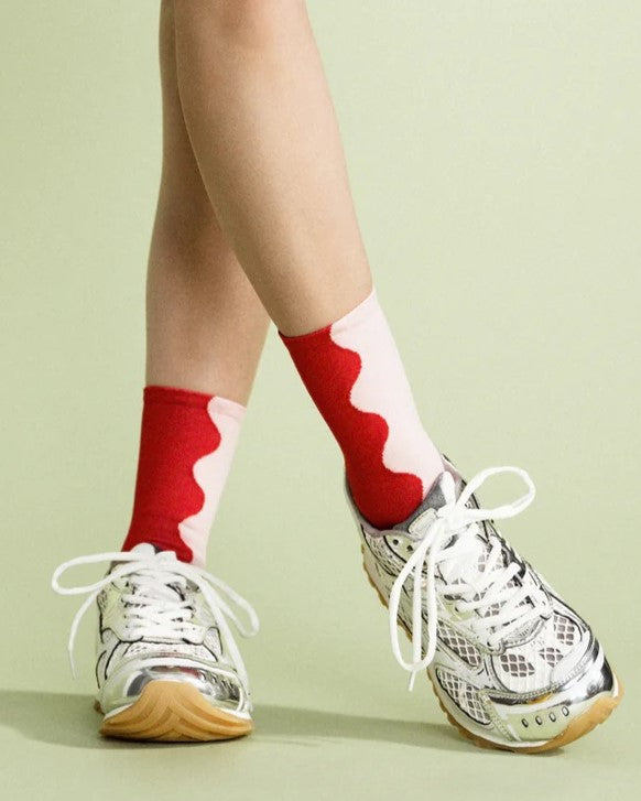 Wavy two-toned red and blush pink socks with a navy heel and toe at Clad, a sustainable clothing store in Asheville, NC