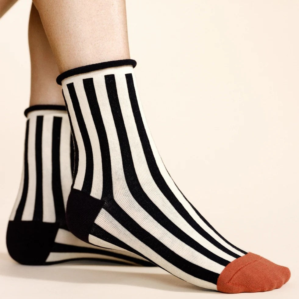 Black and white pantomime striped crewsock from Hansel from Basel with a brown toe and black heel at Clad, a sustainable clothing store in Asheville, NC.