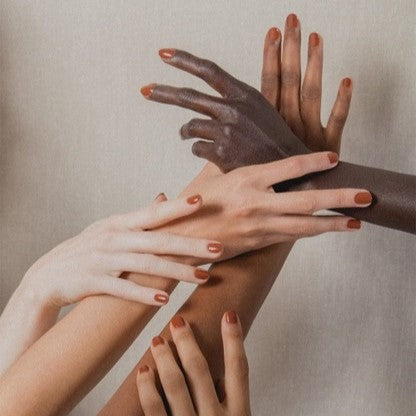 Non-toxic, cruelty-free terracotta nail polish in a rust brown Ghost Ranch on hands.