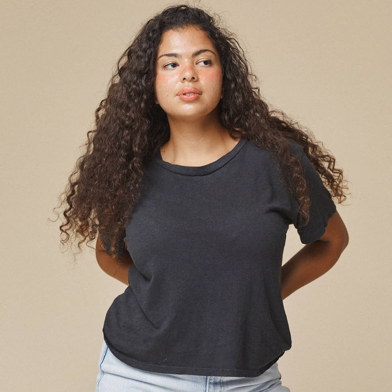 A black crewneck, cropped tee made of cotton and hemp on model.