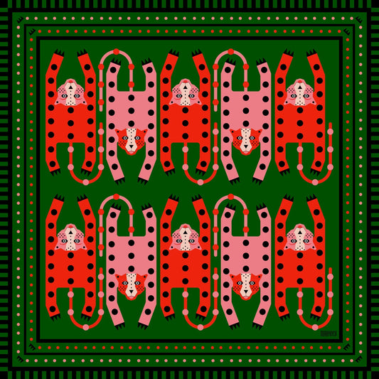 Silk and cotton cheetah print bandana with green background and pink and poppy orange red cheetahs at Clad, a sustainable clothing shop in Asheville, NC.