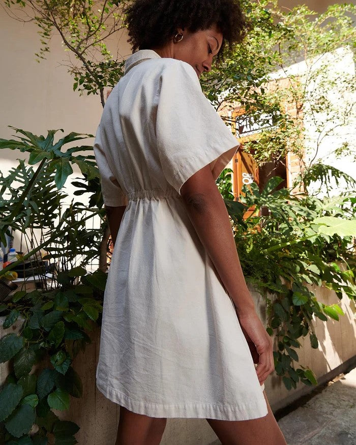 Utility dress from Noble in oat milk with a peter pan collar and cinched waist with zipper down the front at Clad, a sustainable clothing boutique in Asheville, NC