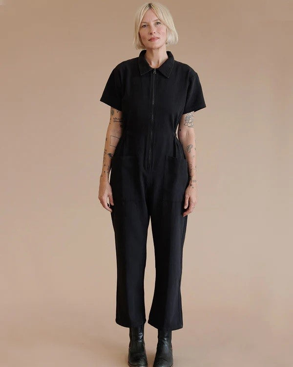 Black zip-up utility suit jumpsuit short sleeves with collar, cinched waist, and cropped ankle straight leg at Clad, a sustainable clothing shop in Asheville, NC.