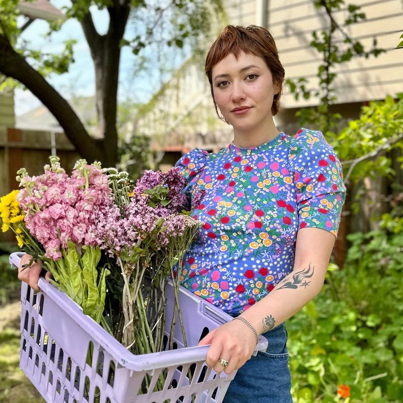Super Bloom puff top by Nooworks with ditsy floral print on blue with athers puff shoulder detail at Clad, a sustainable clothing boutique in Asheville, NC.