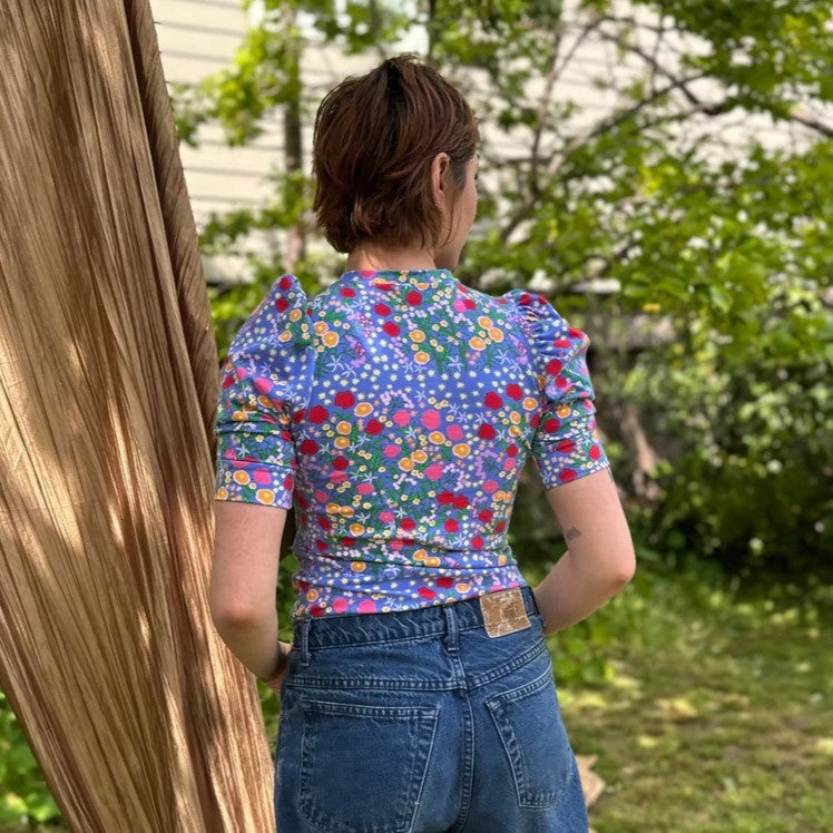 Super Bloom puff top by Nooworks with ditsy floral print on blue with athers puff shoulder detail at Clad, a sustainable clothing boutique in Asheville, NC.