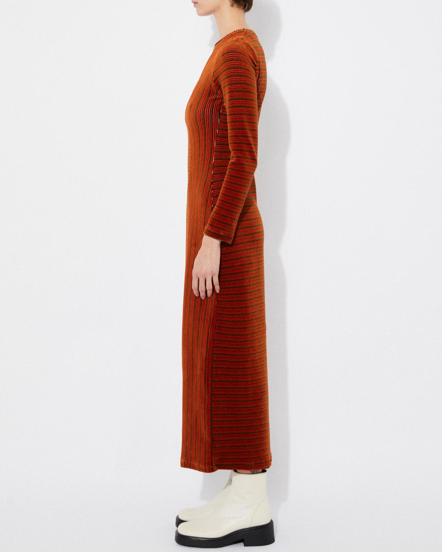 Long-sleeve velvet knit burnt orange rust Corba dres by Rita Row in Spain. Stripes and linework with a midi length and front slit. Paired with chunky white boots.