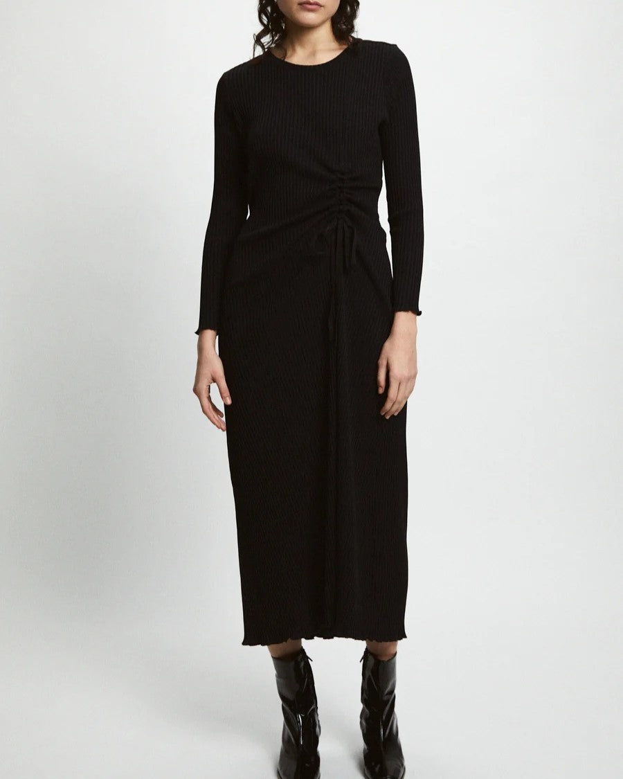 Black ribbed knit Evans Dress from Rita Row paired with black leather boots at Clad, a sustainable clothing boutique in Asheville, NC.