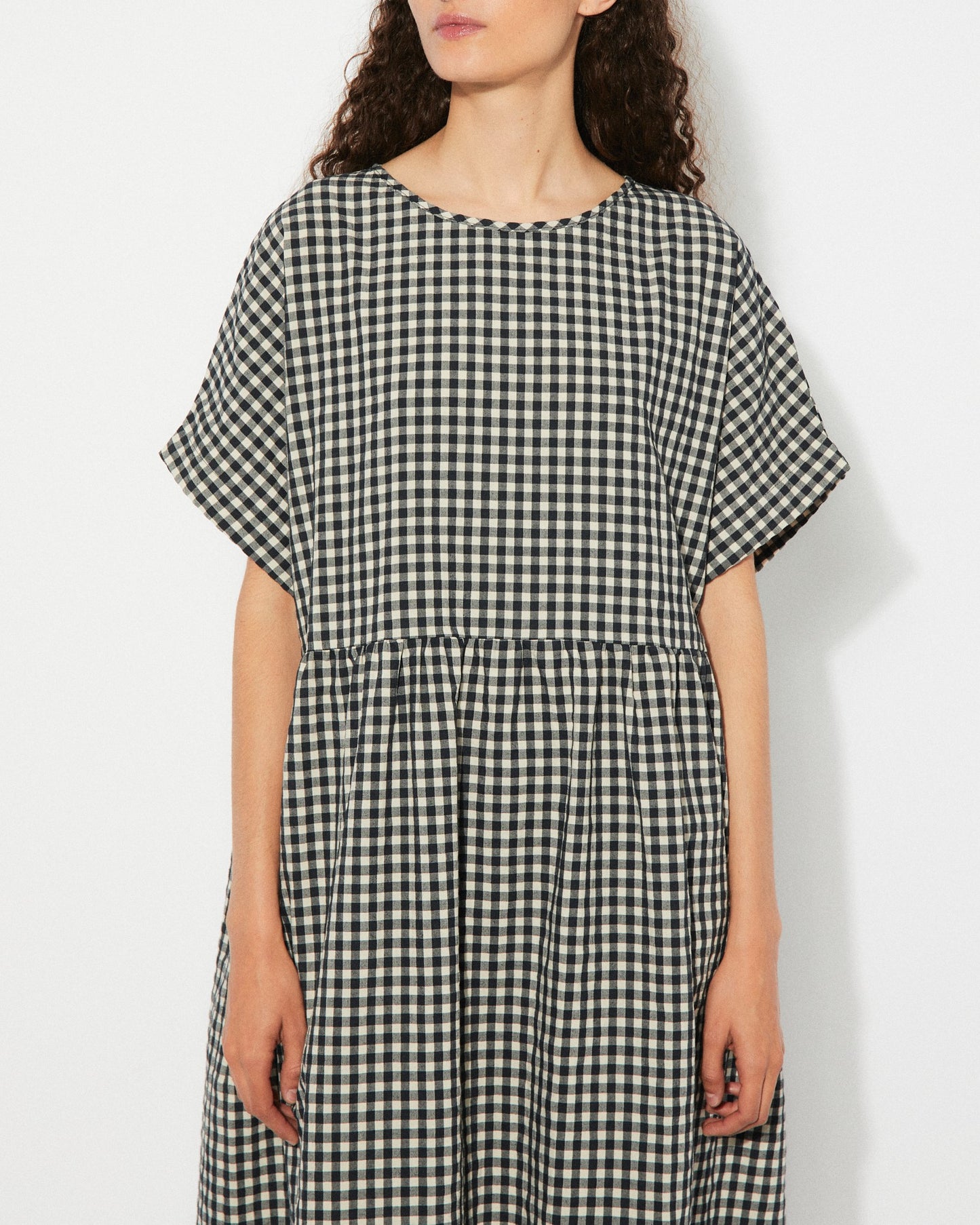 Black gingham checkered Lustre Dress by Rita Row at Clad, a sustainable clothing boutique in Asheville, NC