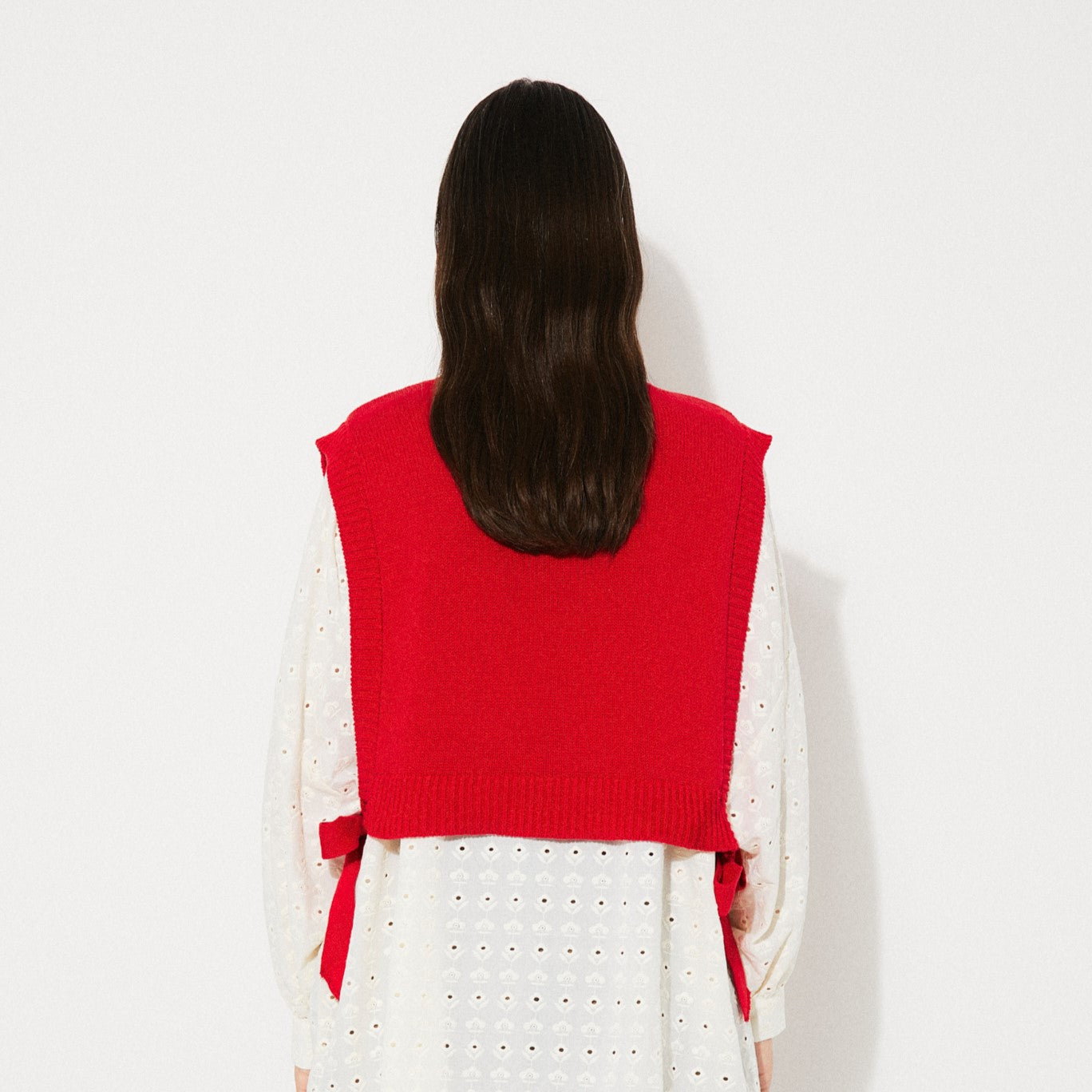 Rita Row red pilea sweater vest with open sides and bow ties on either side at Clad, a sustainable clothing store in Asheville, NC