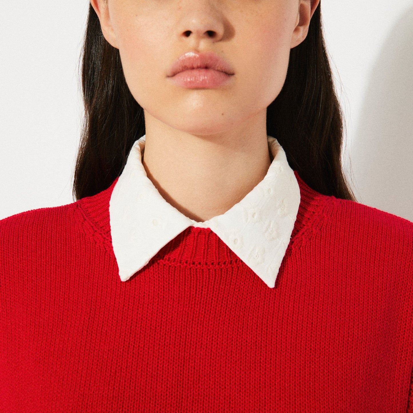 Rita Row red pilea sweater vest with open sides and bow ties on either side at Clad, a sustainable clothing store in Asheville, NC. Paired with an eyelet cream blouse