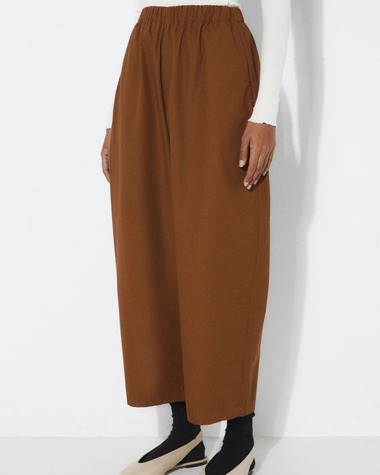 Tobacco brown Turin Pants from Rita Row at Clad, a sustainable clothing store in Asheville, NC. Paired with black socks and beige slingback flats.