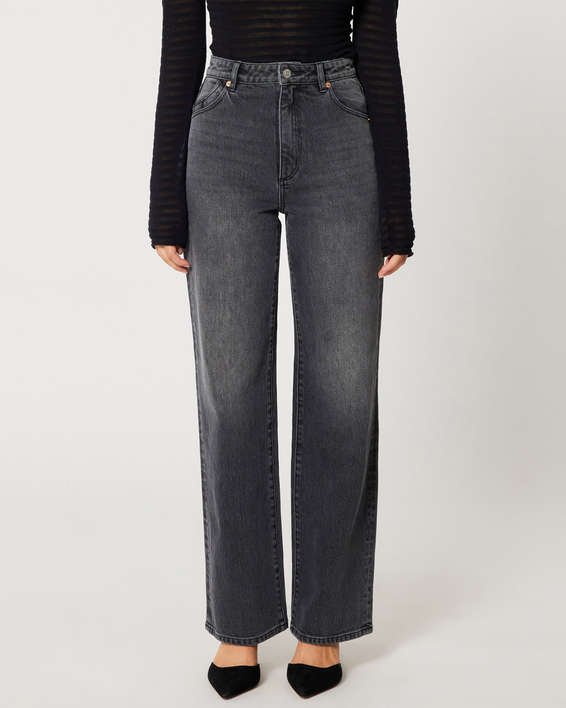 High rise worn black Heidi Jean from Rolla's. Paide with a mesh see-through long sleeve black top an black pumps.