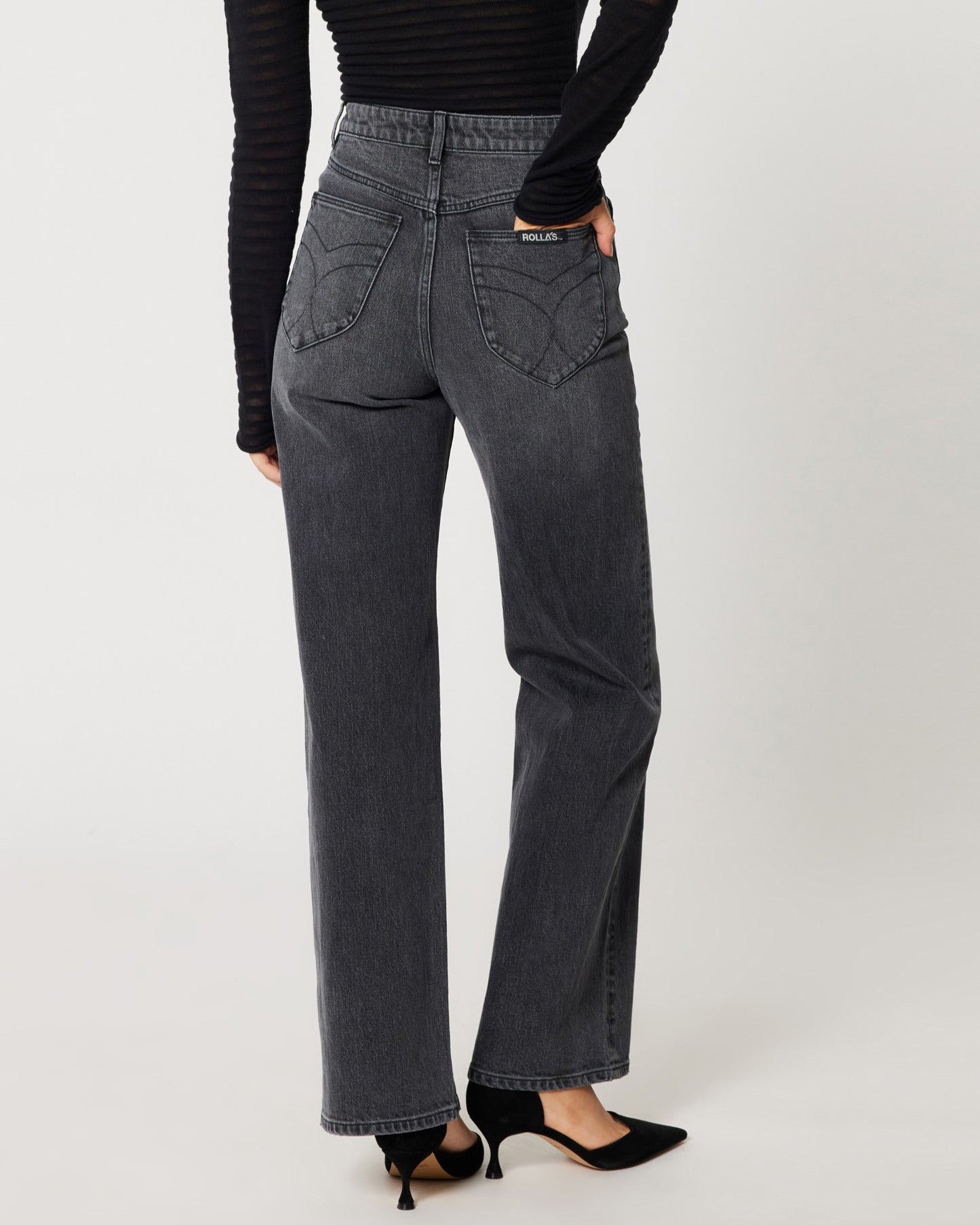 High rise worn black Heidi Jean from Rolla's. Paide with a mesh see-through long sleeve black top an black pumps.