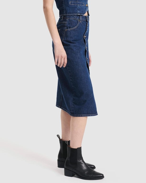 High-wasited denim skirt with button-down front by Rolla's. Paired with a matching denim vest and black ankle boots.