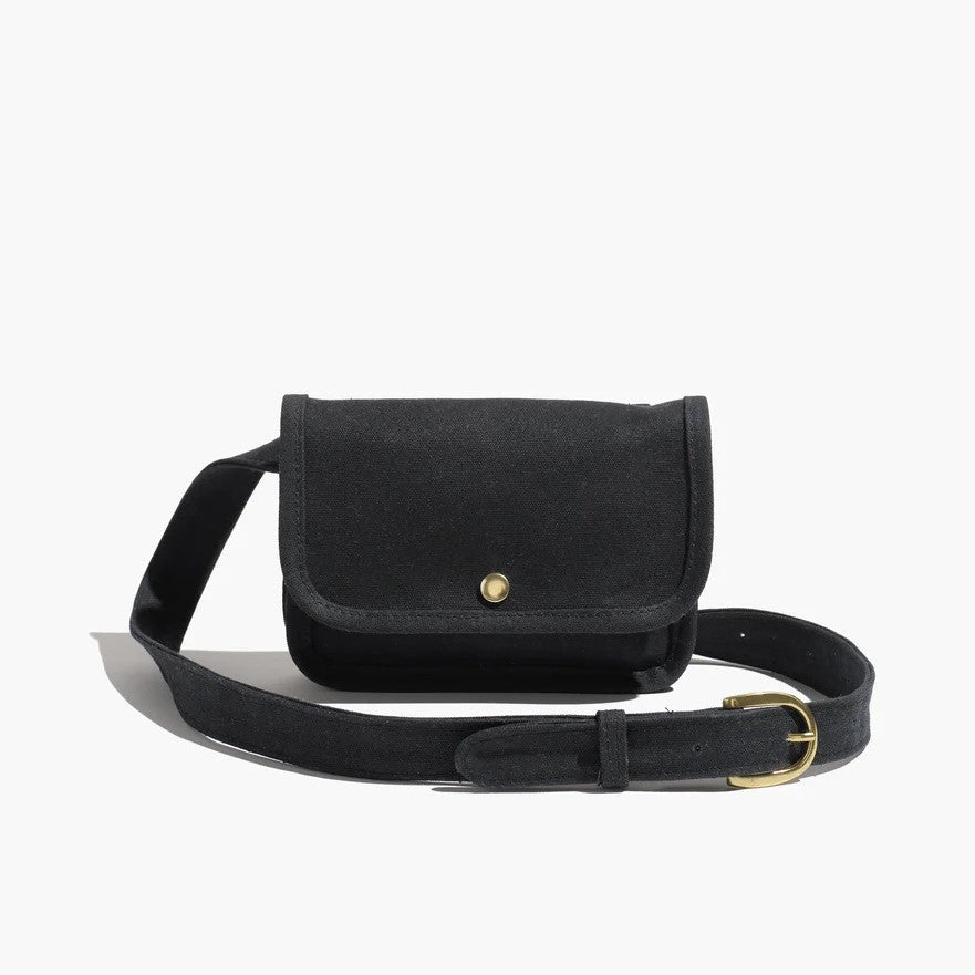 Belt bag by Small Lot Co in black with a metal snap, adjustable waist. Fanny pack style made from cotton canvas.