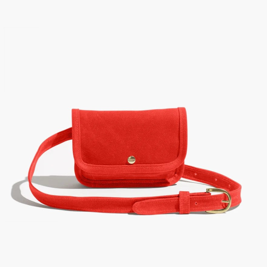 Belt bag by Small Lot Co in blaze bright vibrant red with a metal snap, adjustable waist. Fanny pack style made from cotton canvas.