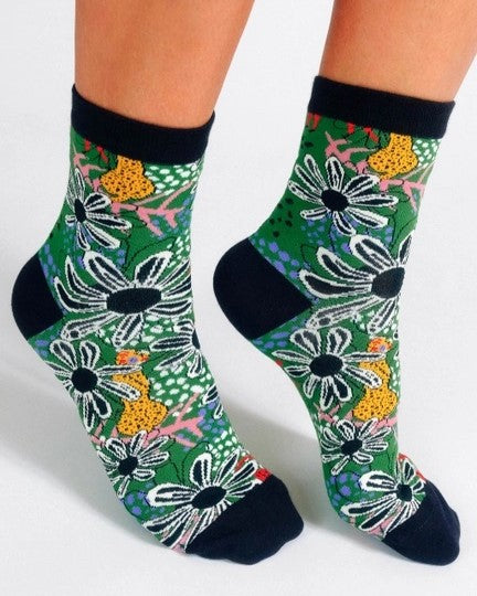 A forest green ankle sock with flowers and cats.