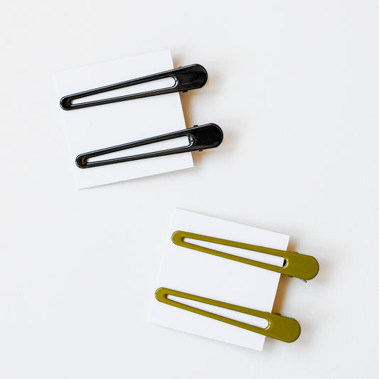 Triangle hair clips in black and olive green to hold back the flyaways.