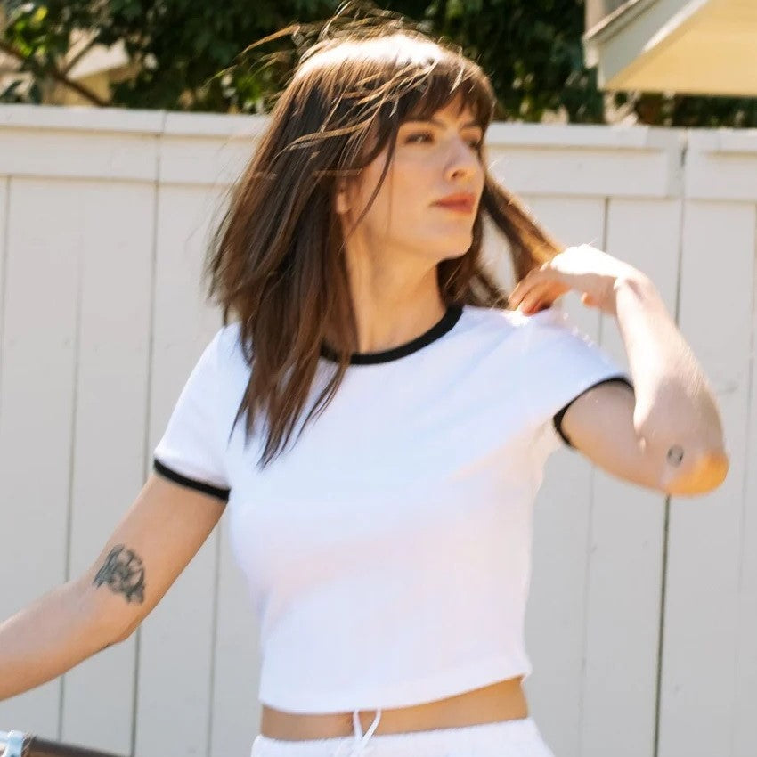 Whitney Top fitted cotton baby tee by Whimsy & Row in white with black trim neckline and sleeves