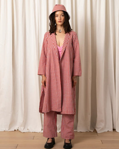 Poppy and ice gingham Notch Jacket by Ali Golden. Paired with matching pants, a pink cami, bucket hat, and chunky black loafers.