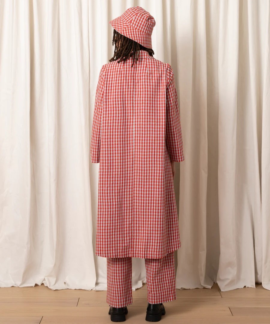 Poppy and ice gingham Notch Jacket by Ali Golden. Paired with matching pants, a pink cami, bucket hat, and chunky black loafers.