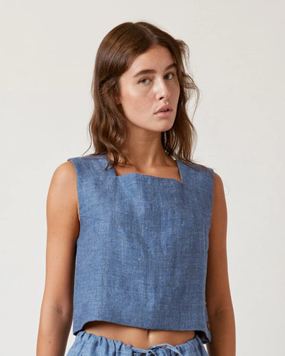 Denim blue boxy linen crop top with button-down side. Paired with matching drawstring pants.