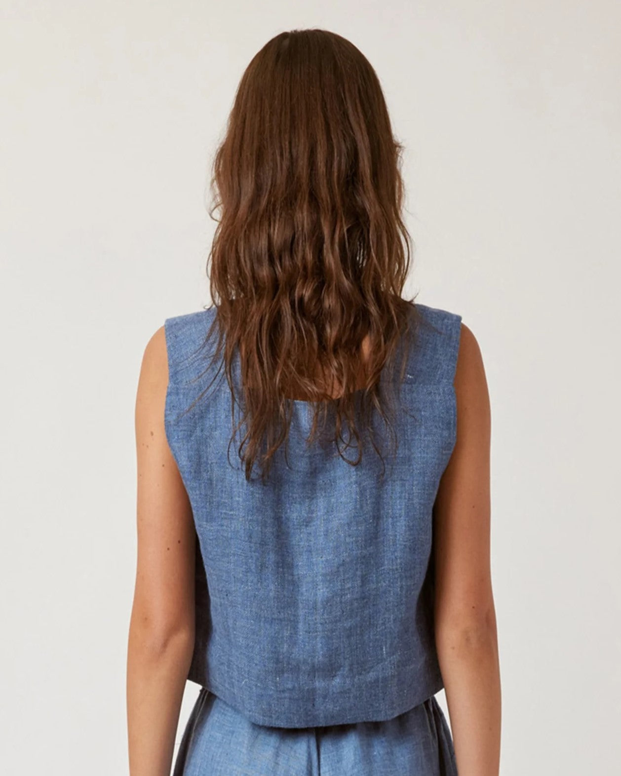 Denim blue boxy linen crop top with button-down side. Paired with matching drawstring pants.