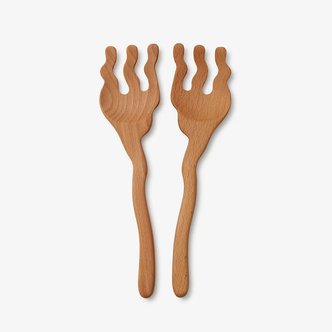 A set of wooden salad hand with squiggles and waves.