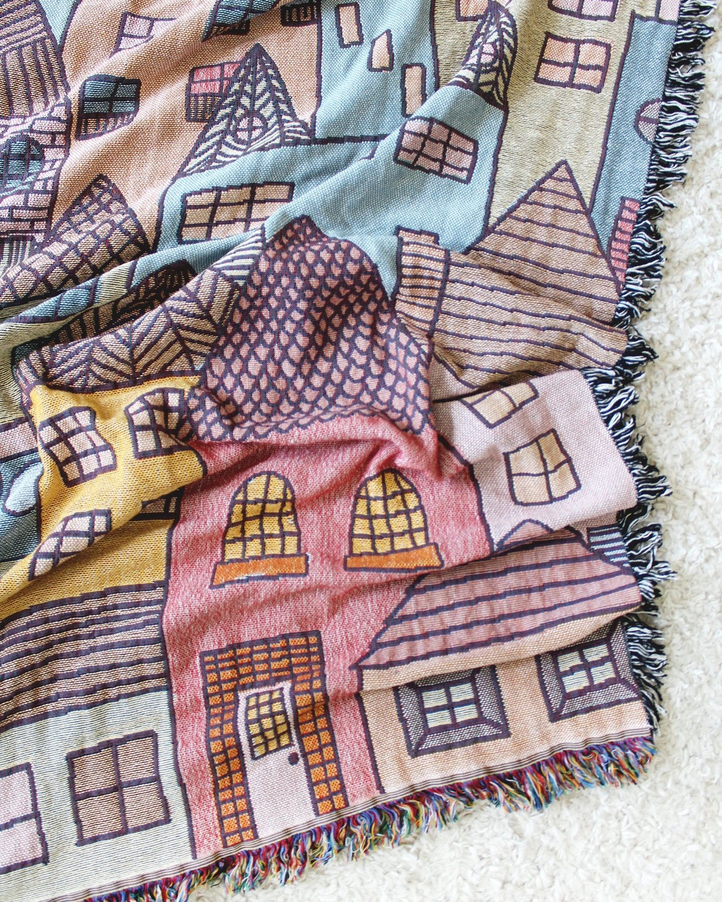 Hillside Village Tapestry Blanket with houses and homes. Reversible with a fringe border.