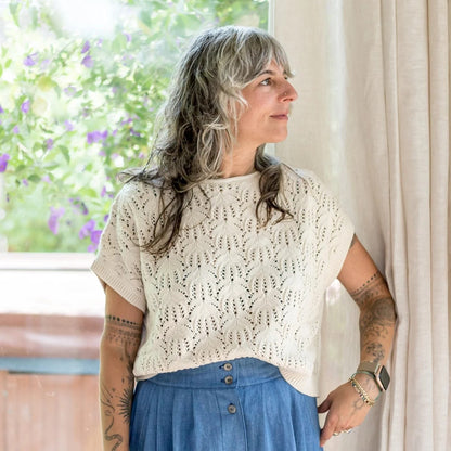 Knit Rosey sweater vest in ivory cream by Curator at Clad, a sustainable clothing boutique in Asheville, NC. Paired with a high waisted button down denim skirt.