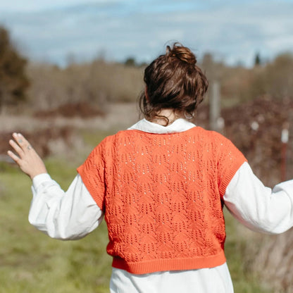 Knit tomato red sweater tank by Curator. Paired with a button-down white linen dress.