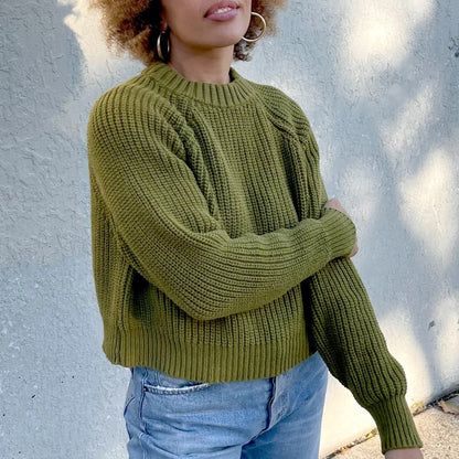 Avocado green cropped knit Sonnie Sweater by Curator in San Francisco, California. Paired with a light-medium wash blue denim.