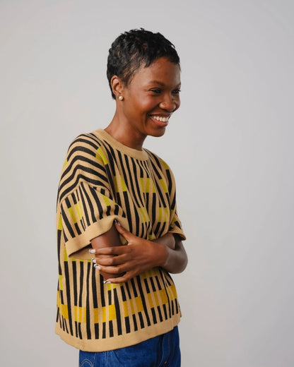 The Endery Bauhaus short sleeve sweater in peridot with beige and black stripes and chartreuse detail