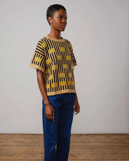 The Endery Bauhaus short sleeve sweater in peridot with beige and black stripes and chartreuse detail