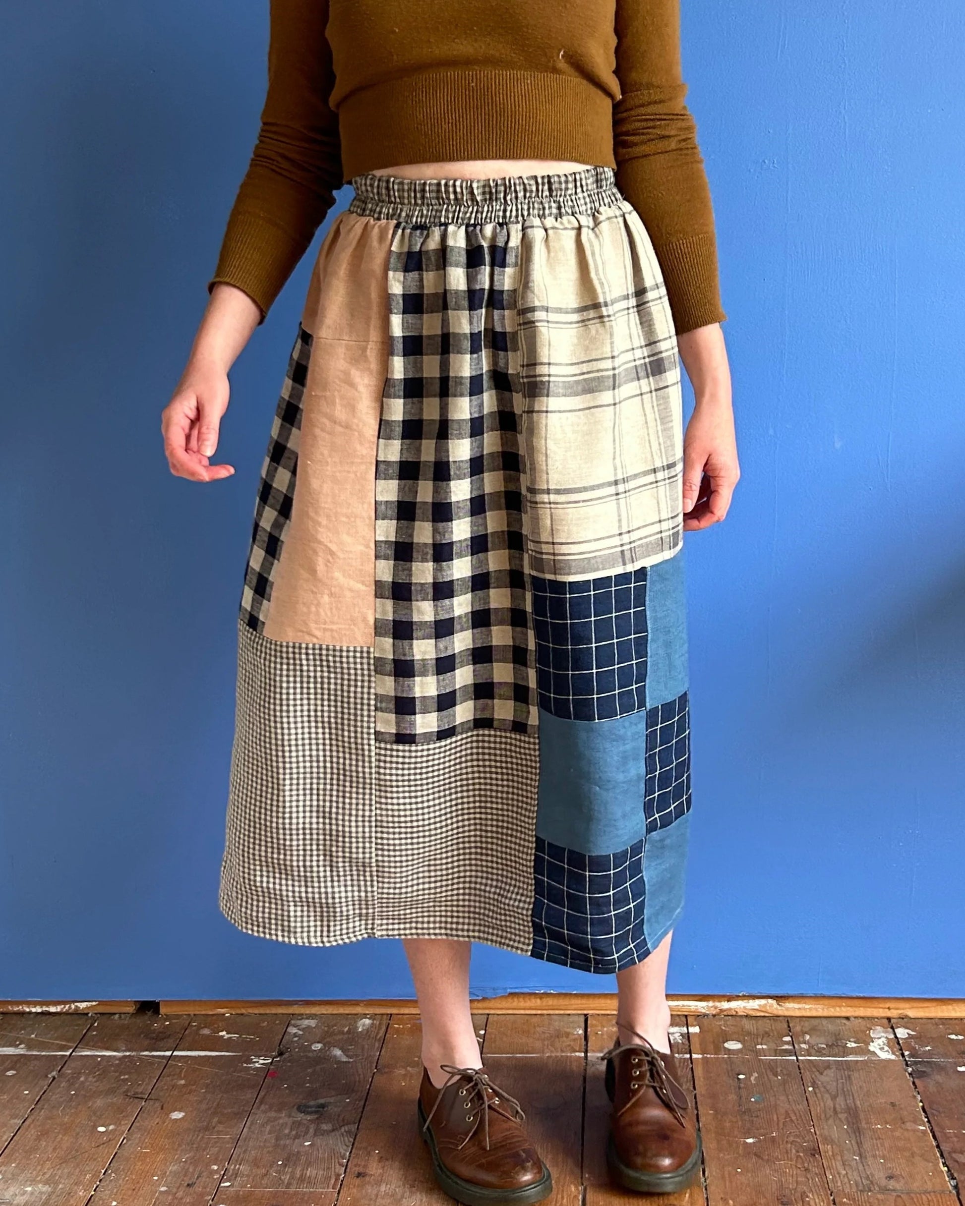 Quilted Sadie Skirt patchwork from Ersa Fibers with an elastic waist, paired with leather loafers and an ochre brown knit sweater