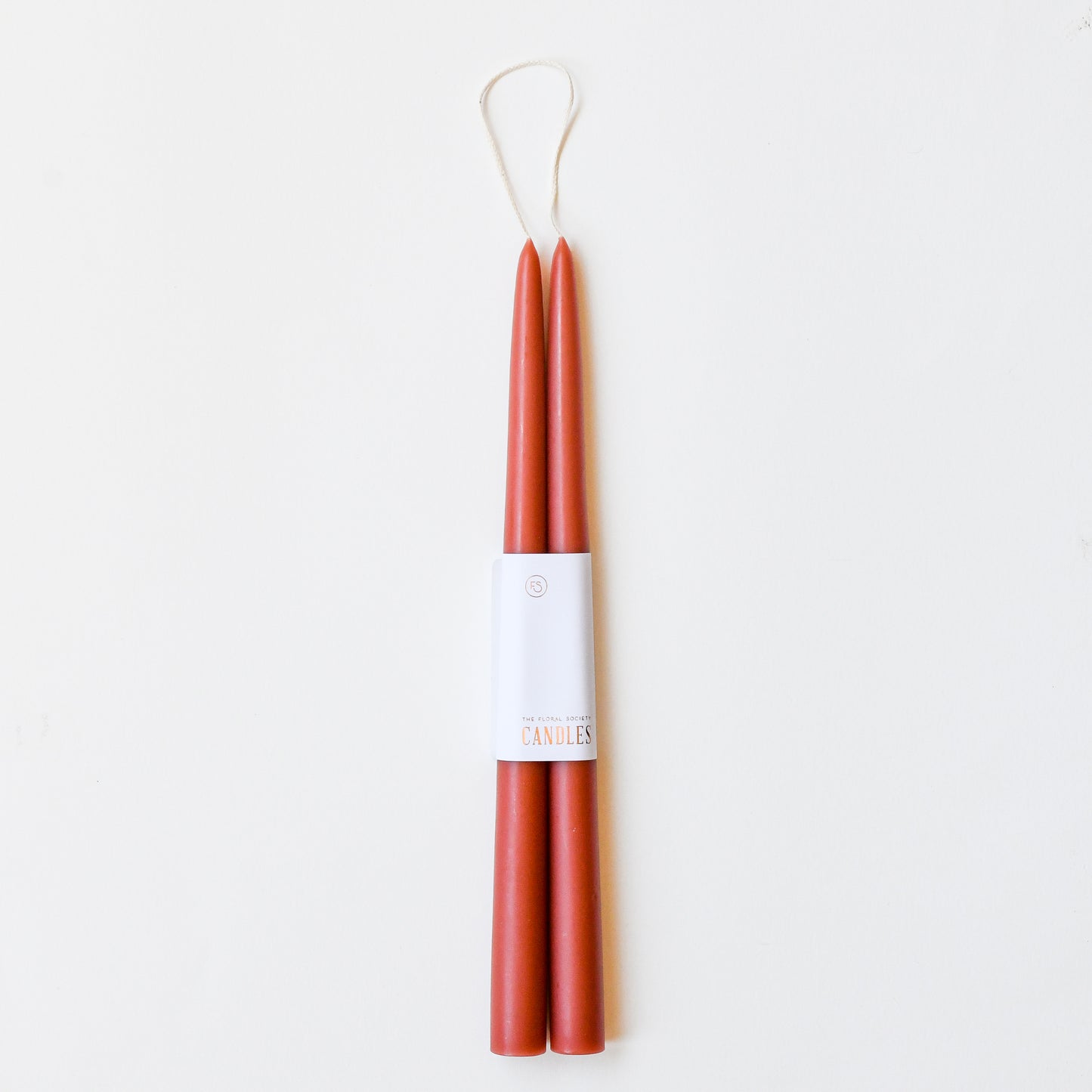 12" taper candles in a set of two in rose clay red.