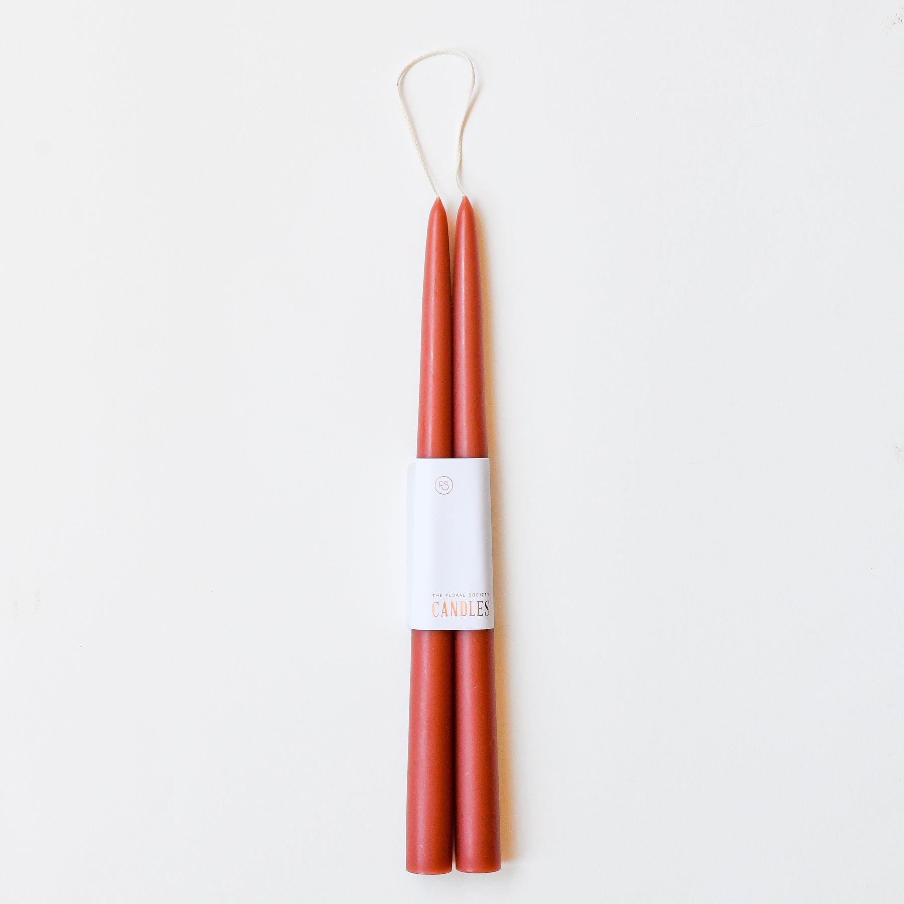 12" taper candles in a set of two in rose clay red.