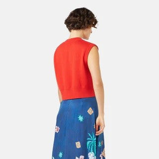 Red knit sweater vest tank Tara Studio by Gorman. Sleeveless with lavender pink orchid flowers. Paired with medium blue abstract print midi skirt.