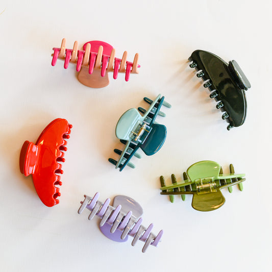 Hair claws by Nat + Noor in pink, red, bue, green, and lavender purple.
